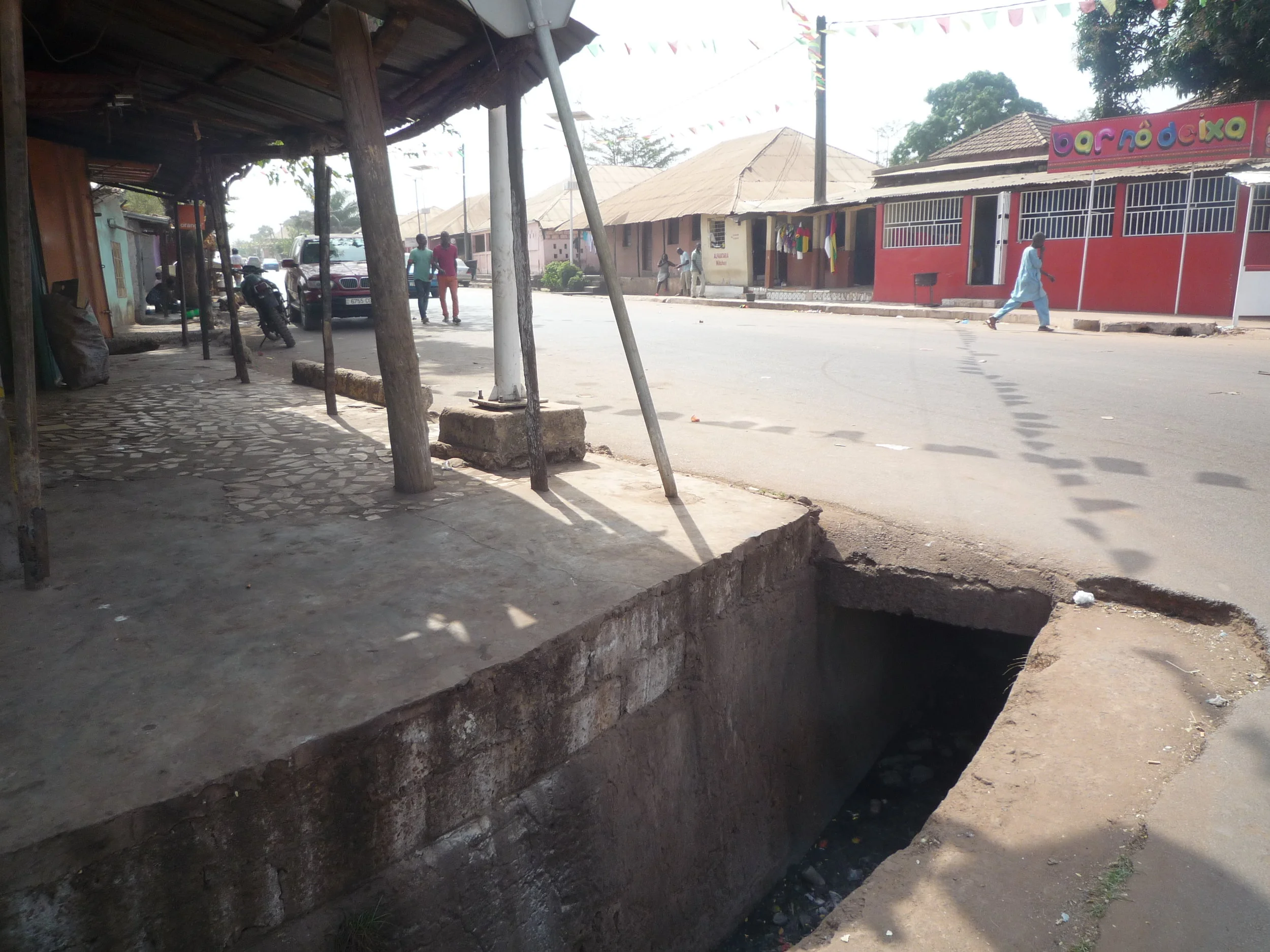 One of Cupilum’s main streets. During the 1998 conflict residents sheltered themselves from bombs in the subterranean sections of drainage ditches such as the one in the foreground.