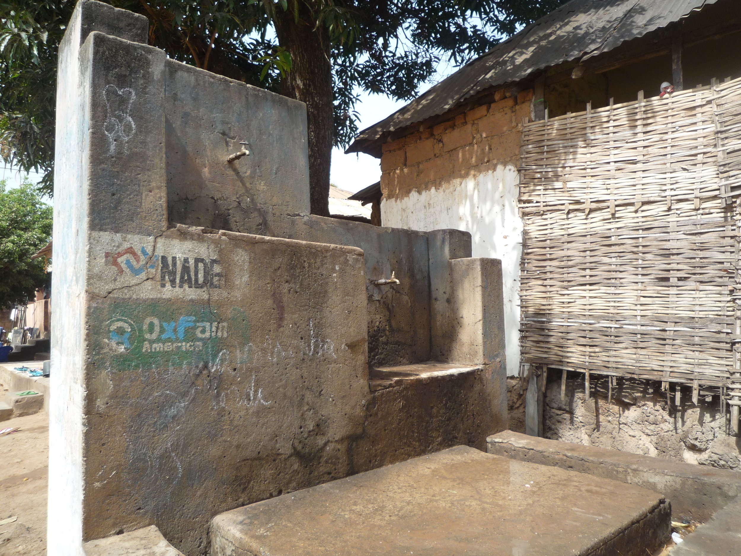 Rebuilt water point with NGO stamps.
