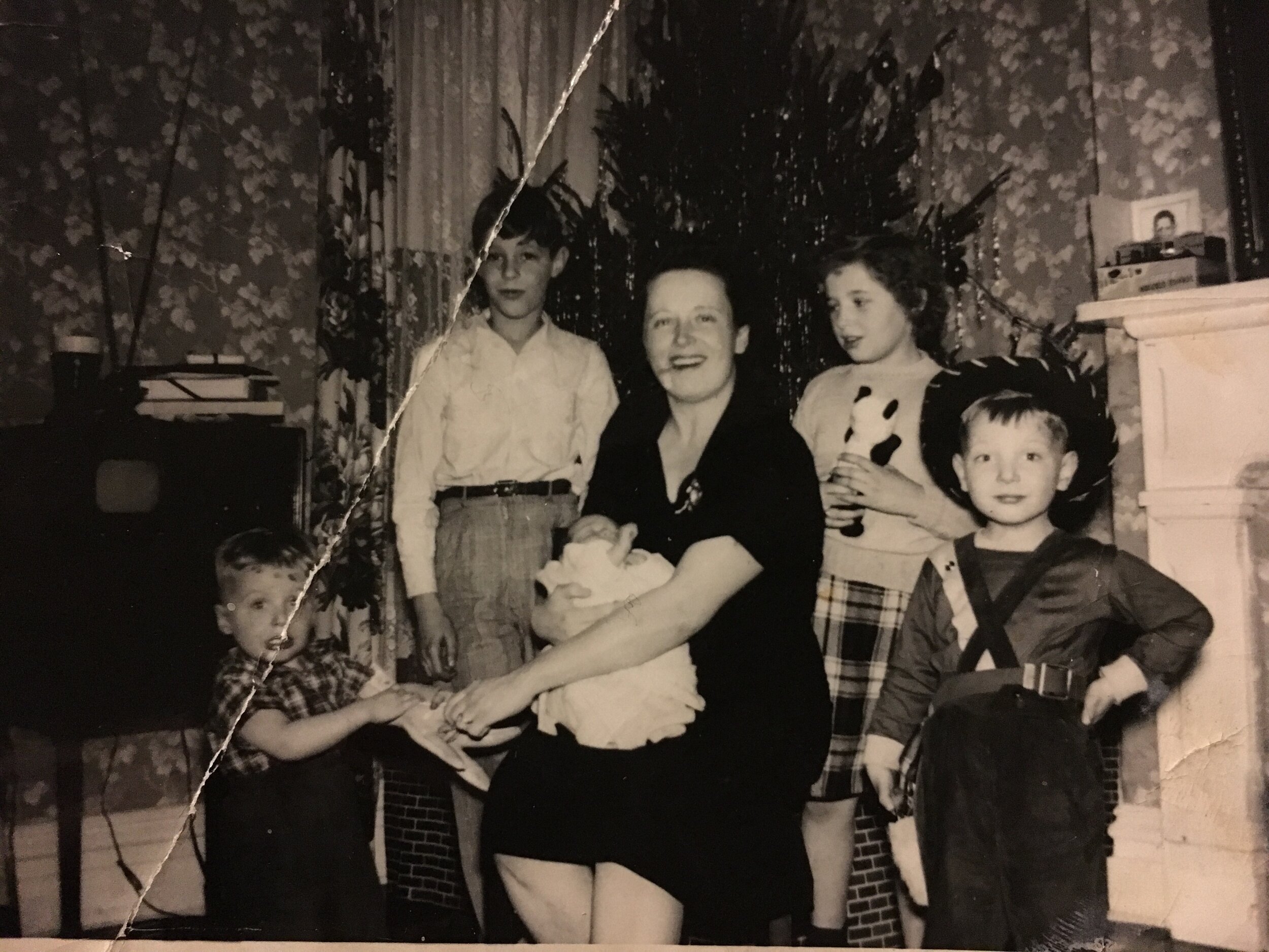 My mother, holding me in December 1950. with my four siblings.
