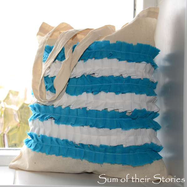 an old shopping tote bag with stripes of blue and white fabric sewn in ruffles, resembling cornishware pottery