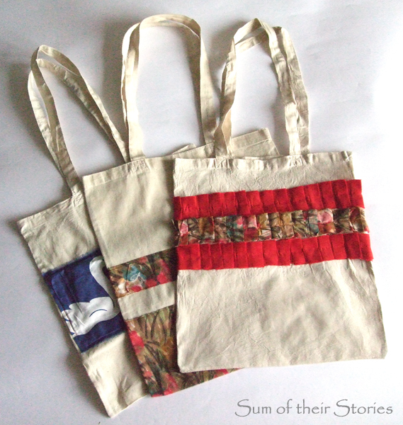 plain shopping bags embellished with scraps of colourful fabric