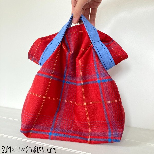 Red check bag with a contrast handle pattern