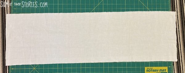 A rectangle of plain cloth on a cutting board