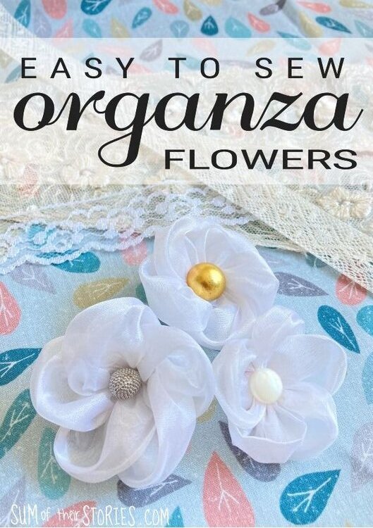 3 organza flowers on a lace background