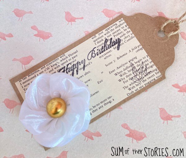 A pretty gift tag made with book paper and an organza flowers
