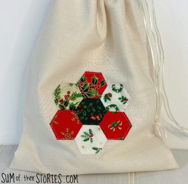 a fabric christmas gift bag with patchwork motif