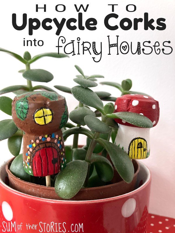 2 wine corks painted like fairy houses in a pot with a jade plant