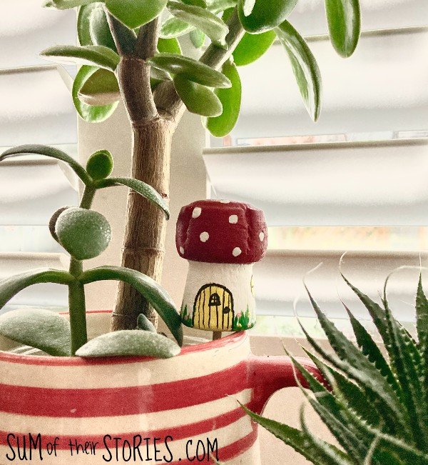 A mushroom fairy house made from an old cork in a pot plant