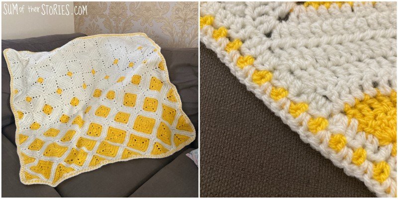 A yellow and white granny square baby blanket