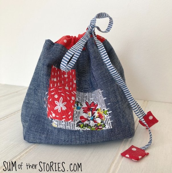 A decorated komebukuro style bag in blue and red fabric