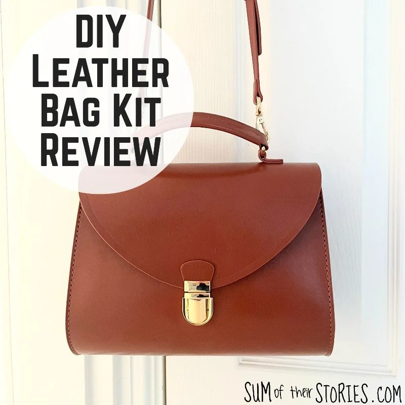  simple brown leather handbag hanging from a banister  