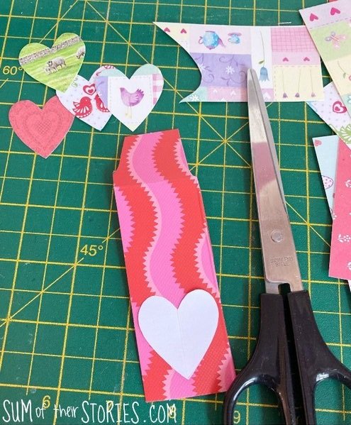 Cutting out heart shapes from scraps of card