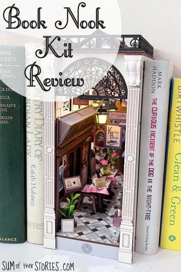 book nook on a bookshelf surrounded by books