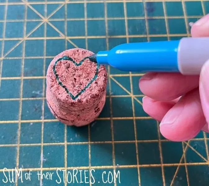 drawing a heart on an old cork