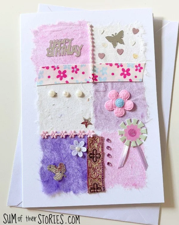 greeting card made with tissue paper squares in pinks and purples embellished with beads, ribbon and sequins