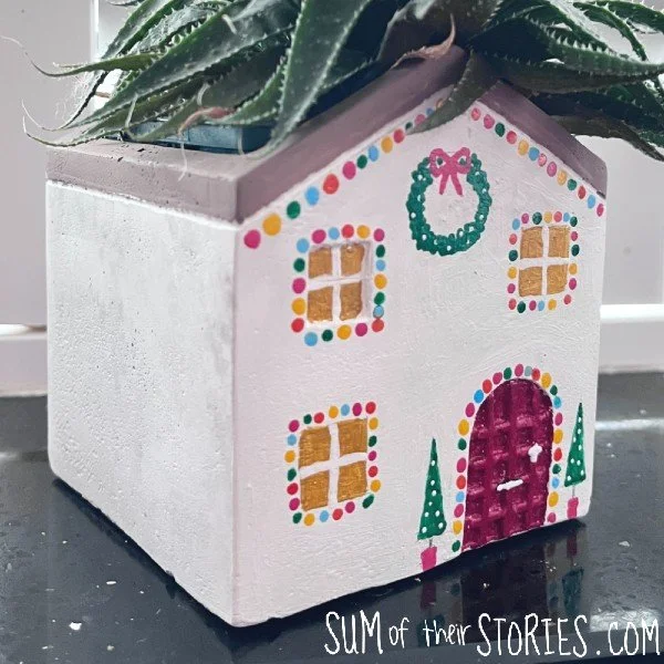 christmas houseplant planter painted as a christmas house