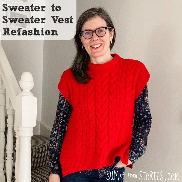 A 50 something year old white woman with long brown hair wearing a bright red sweater vest made by refashioning an old sweater