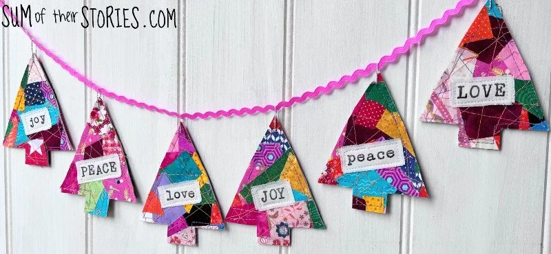 a garland of brightly coloured christmas trees made from scraps of fabric