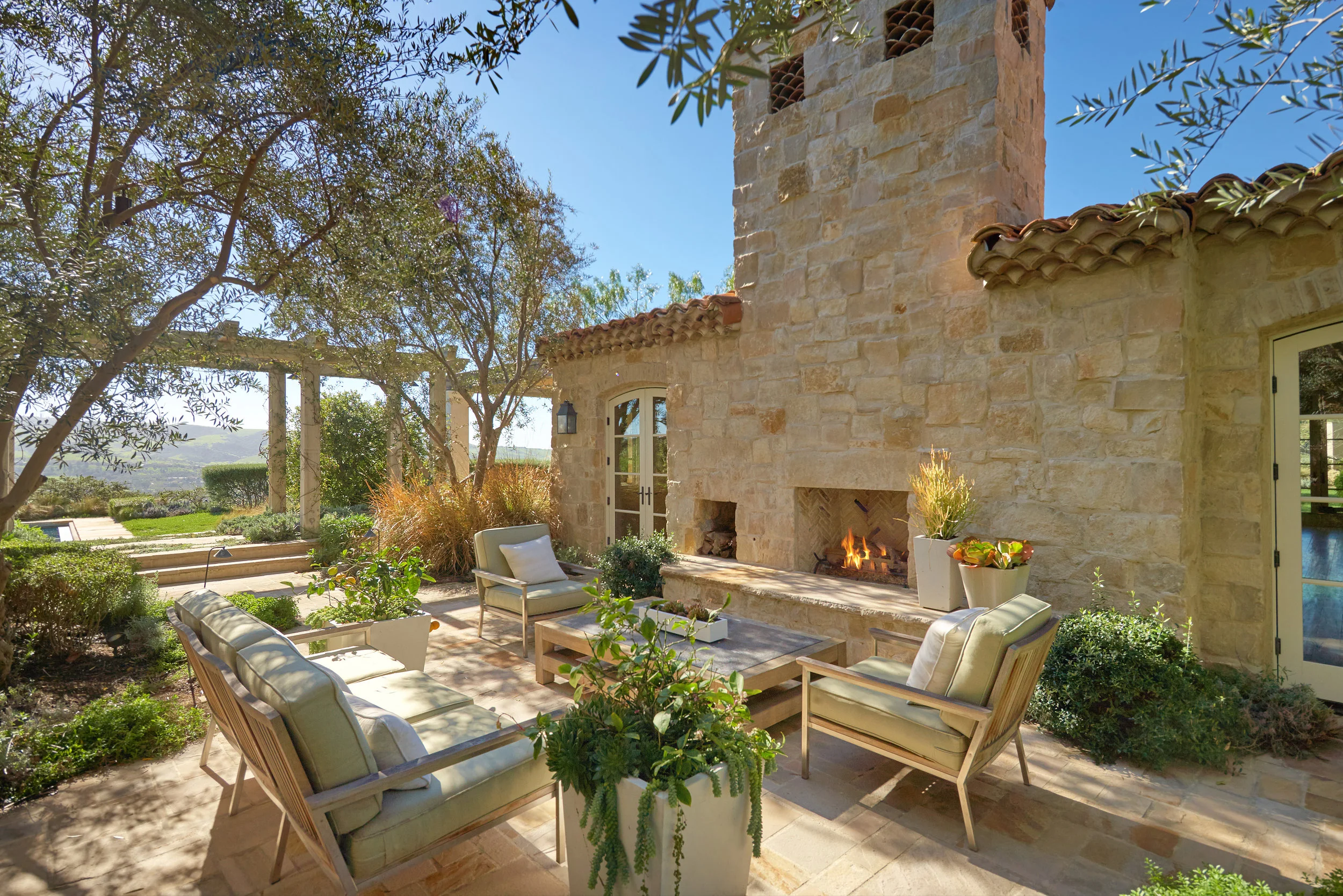 Shady Canyon - Provence Home Outdoor Fireplace by Oatman Architects