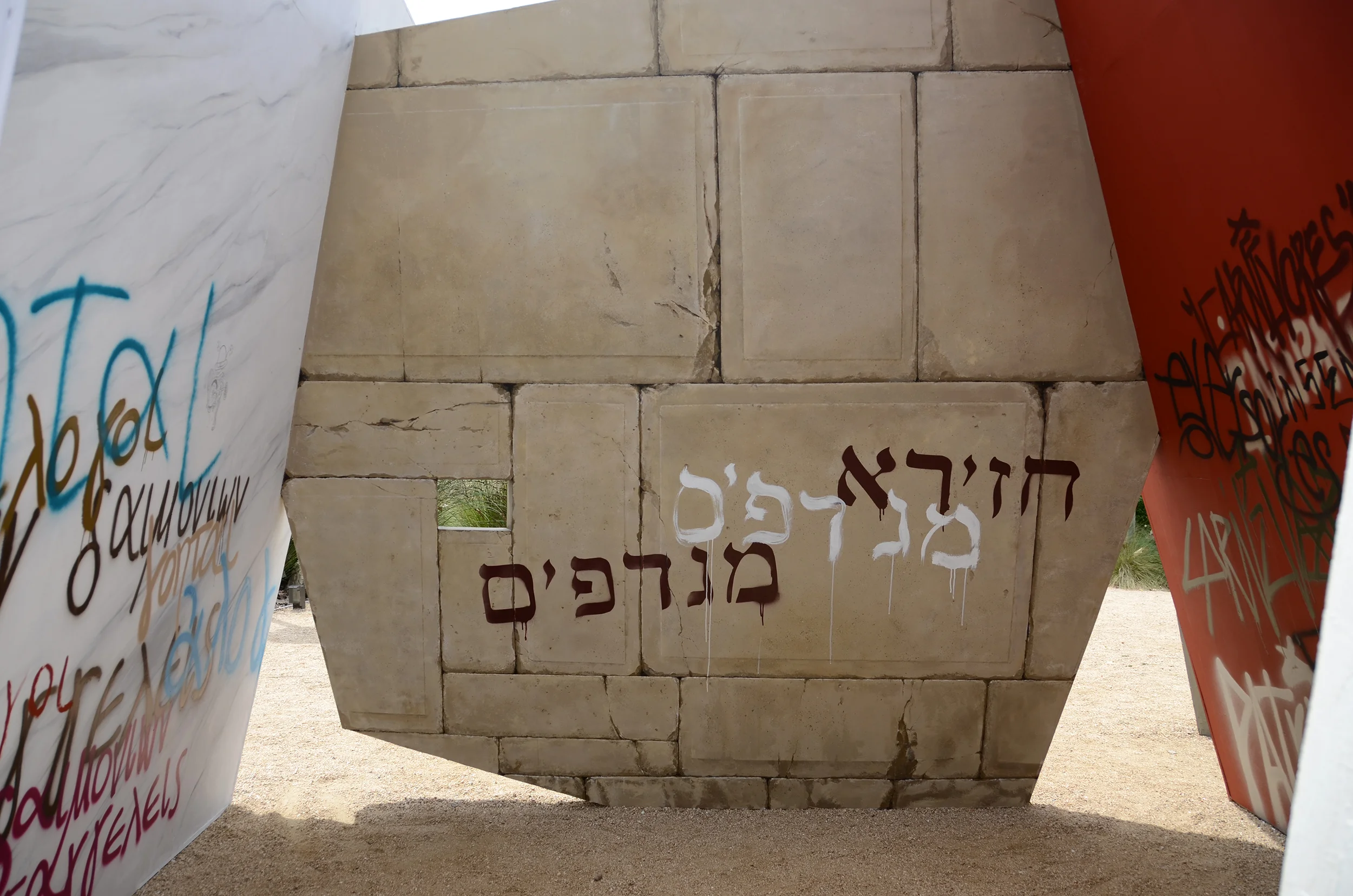 The graffiti was written in Greek, Hebrew, and Latin, and used derogatory phrases that were associated with the early Christians; Greek: Conjurers, Absurdists, Worshipers of Foreign Demons. Hebrew: Swineherd (Pig feeders), and Blasphemers. Latin: Over-turners, Arsonists, Unpatriotic, Cannibals. Paul was beheaded around 70 AD.