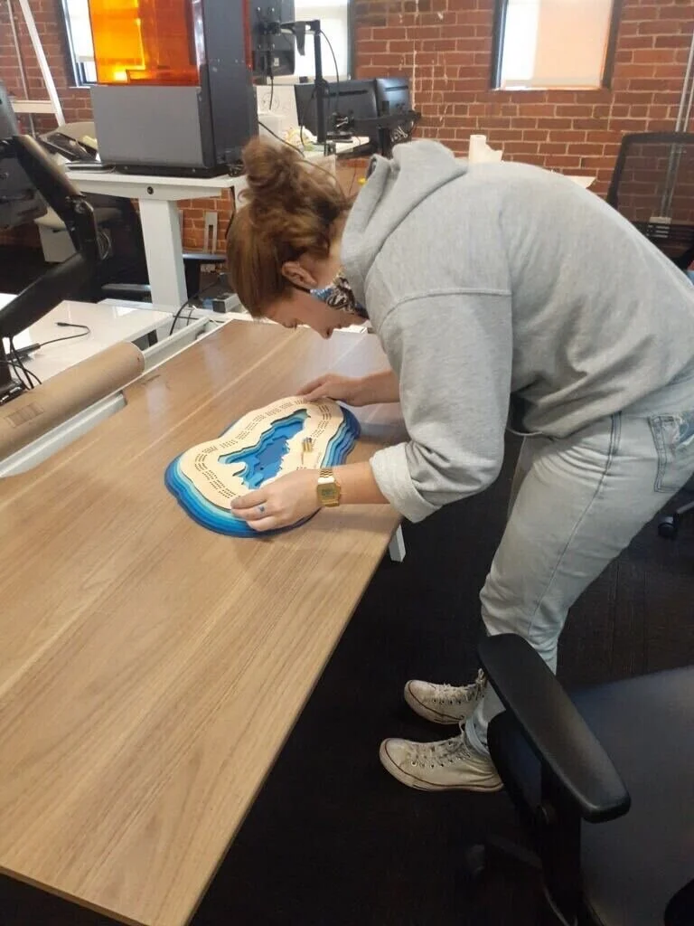  Each of the layers was laser cut from 1/8” plywood and painted with acrylic paint. On the first 3 layers, the cribbage holes double nicely as alignment holes. 