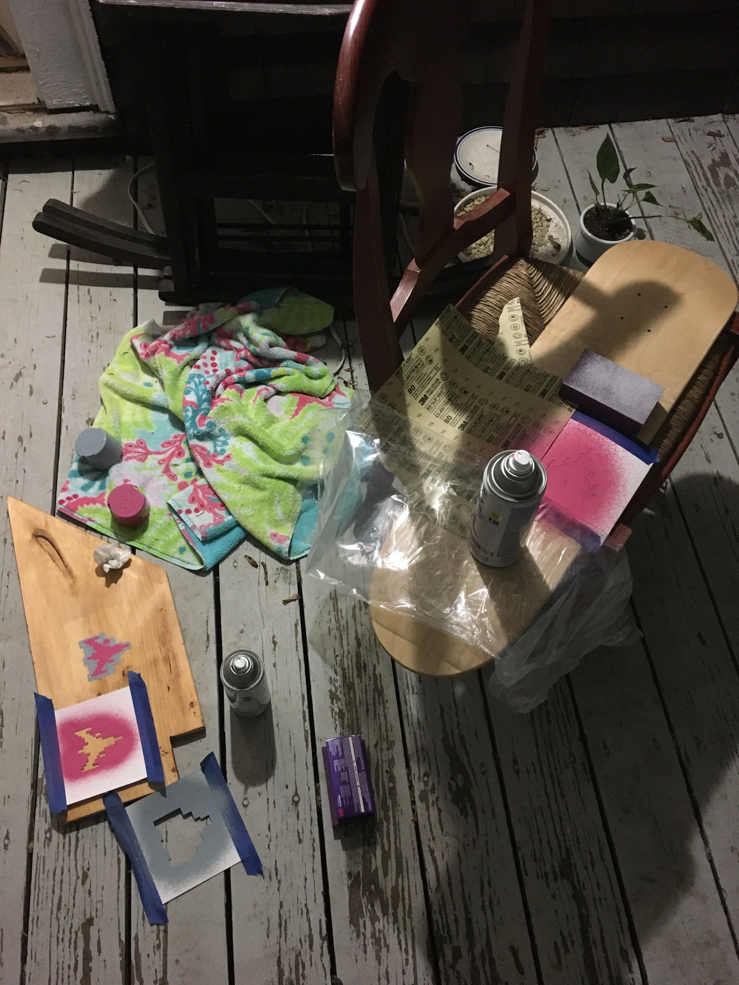  Spray paint setup, showing the stencils and a test piece of wood. 