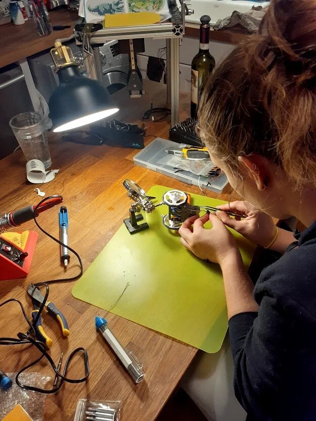  Soldering the wires onto the tabs on each motor. 