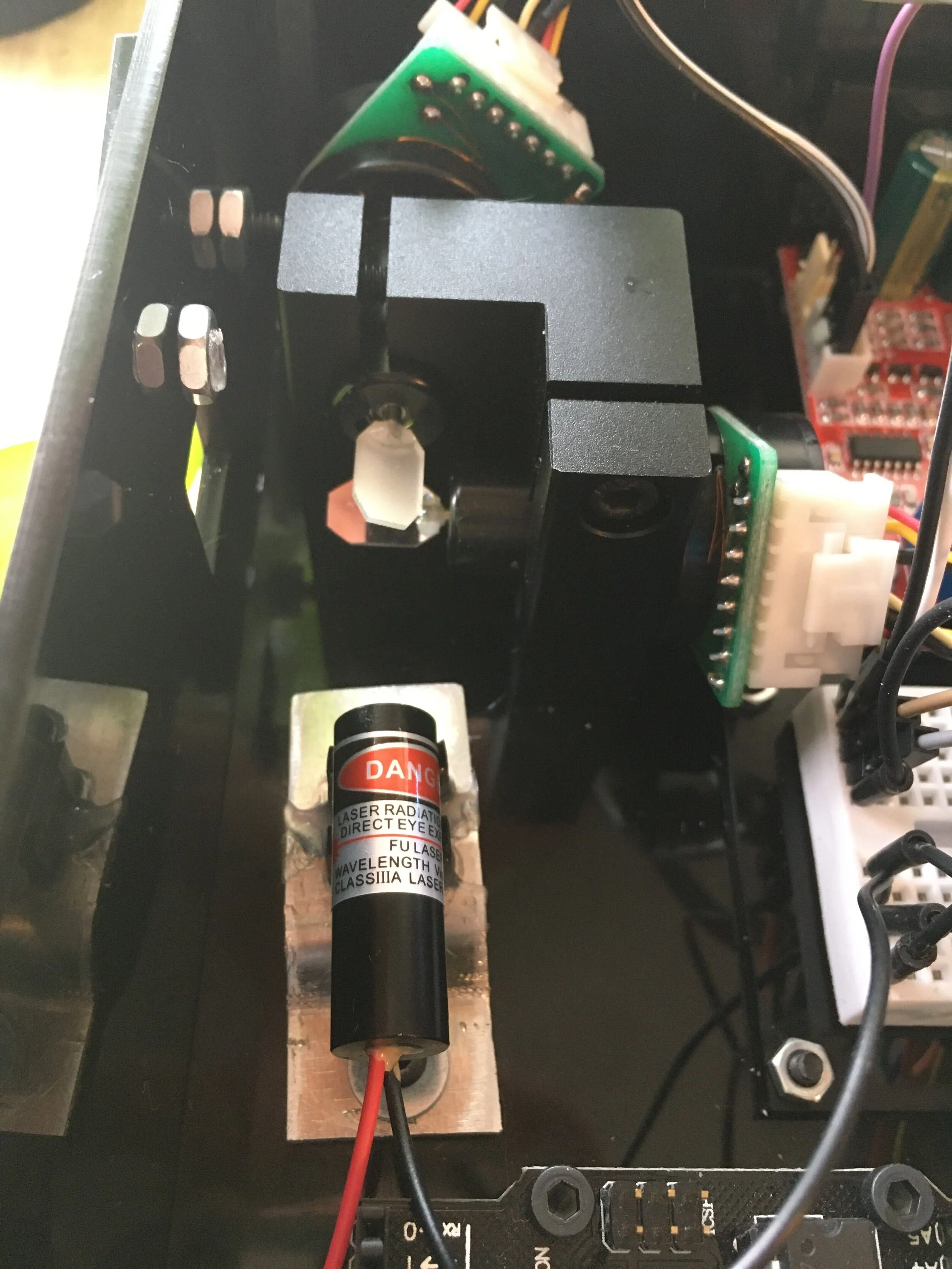  Close up of laser adjustment. In order to for the laser projector to work without skewing, there needs to be good alignment between the laser and each of the galvo mirrors. In order to achieve this, I created a laser mount with horizontal and vertic