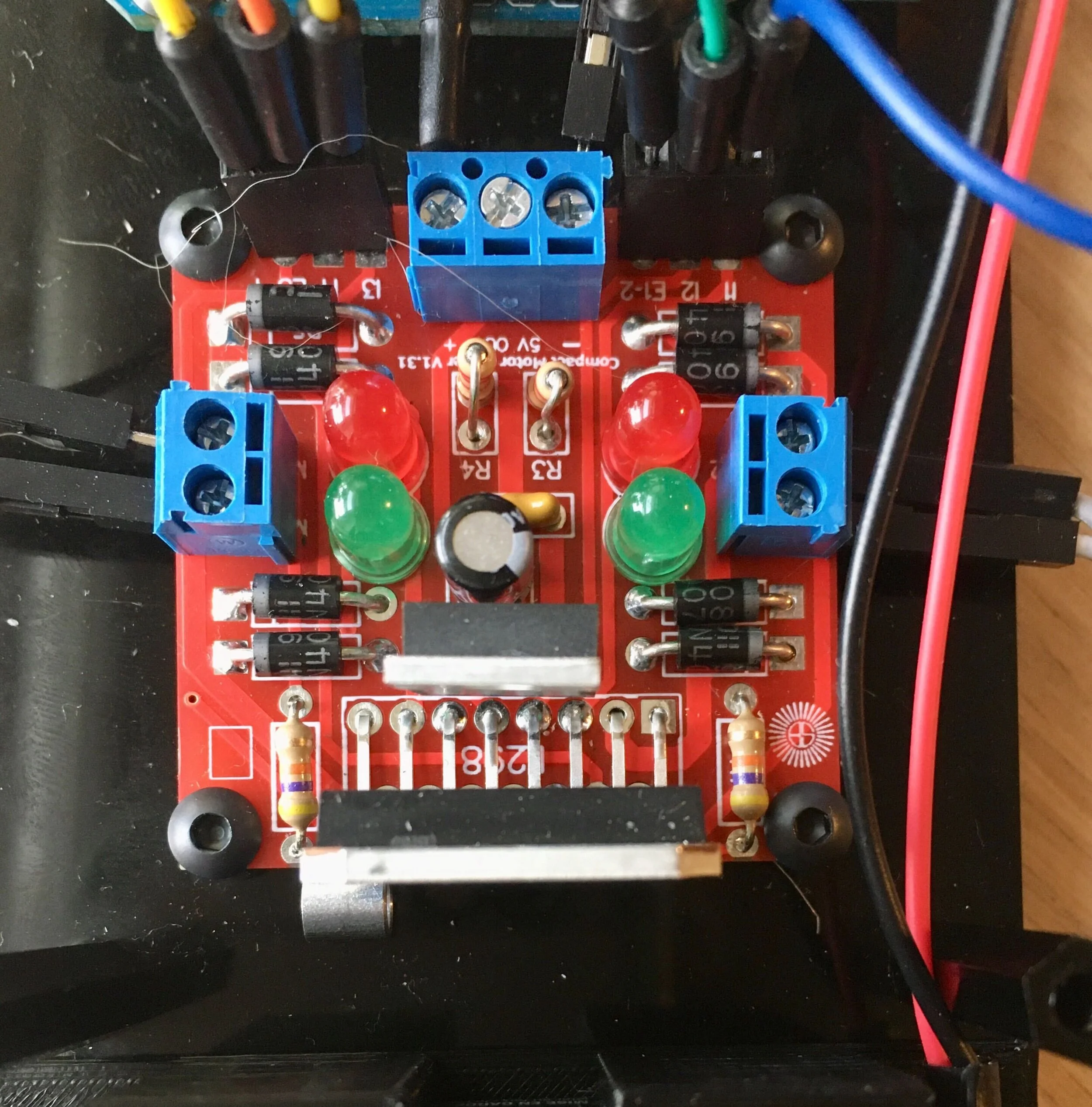  Close up of L298 motor driver after soldering on each component. Red and green LEDs represent forward and backward for each motor. 