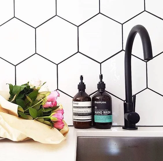black and white - the most classic combo. why would grout be any exception? also please note the hex and matte black fixture - v haute.