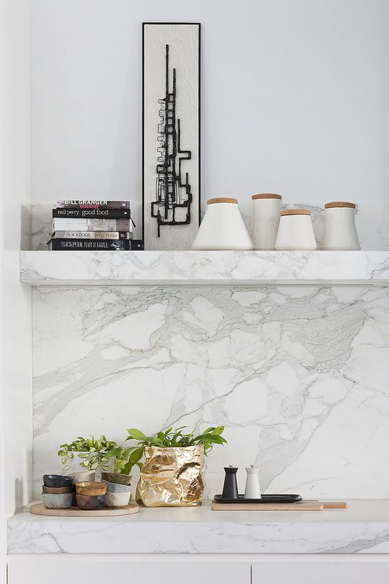 a slab backsplash doesn't have to be huge, nor does it have to necessarily have to break the bank. most standard slab sizes comes in 30 x 72" configurations, which is generally enough to cover a typical sized backsplash. if needed, an adequately placed seam will be okay, and if ordered together, multiple slabs from the same batch will go together just fine.