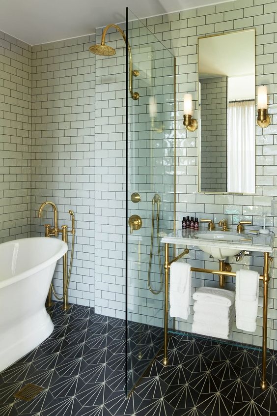 waterworks bathroom with shower and console in unlacquered brass - the ultimate guide to luxury plumbing by the delight of design