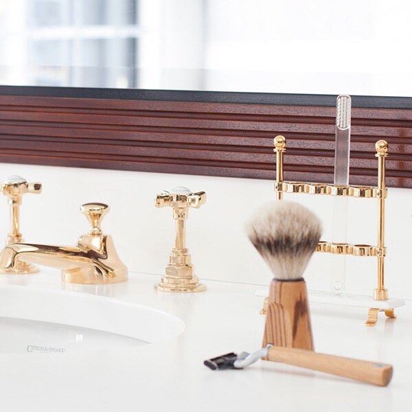 czech & speake traditional widespread lav faucet with low spout and tall cross handles with porcelain inset in unlacquered brass - the ultimate guide to luxury plumbing by the delight of design