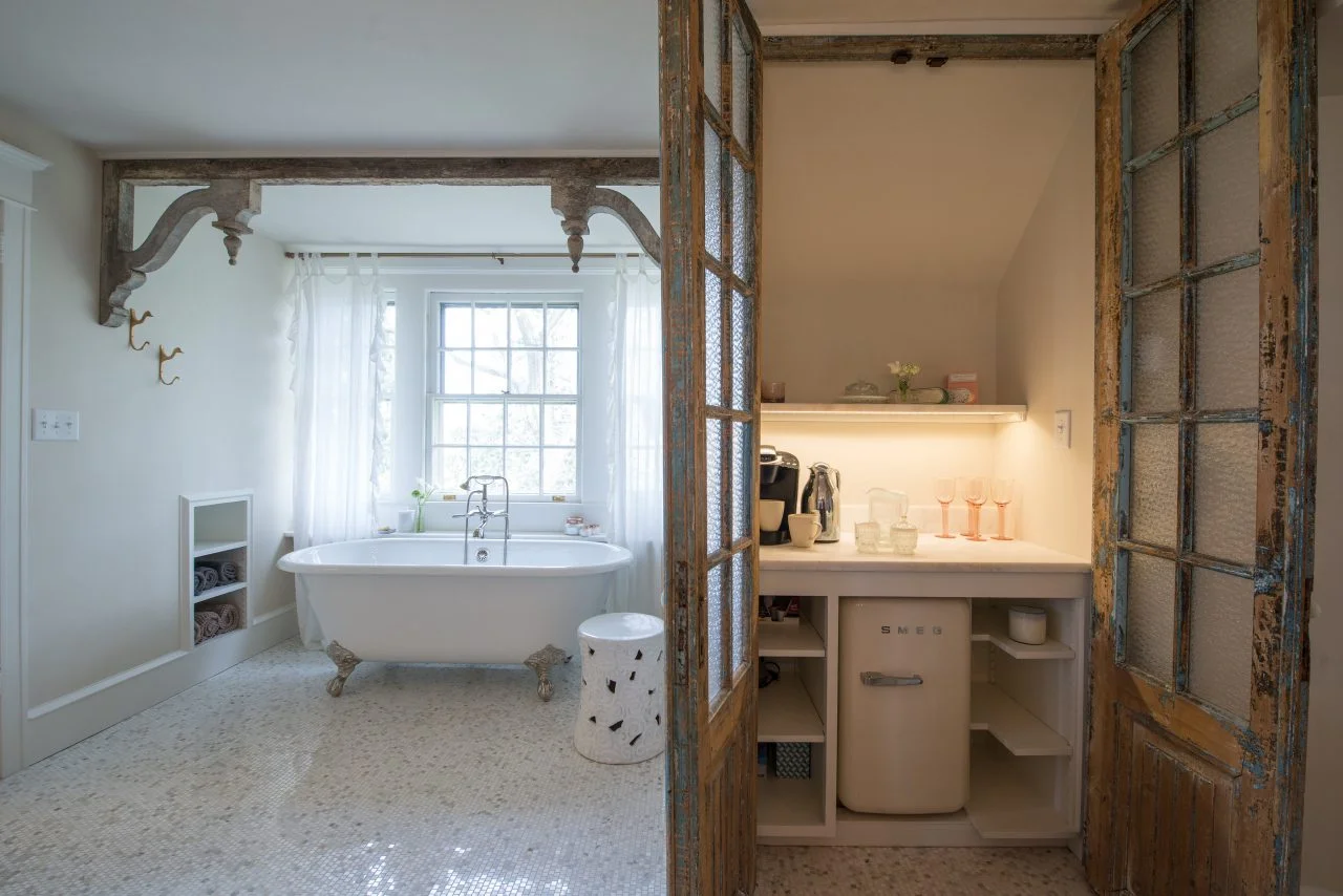 rustic traditional coffee bar in master bathroom with french doors smeg fridge clawfoot tub