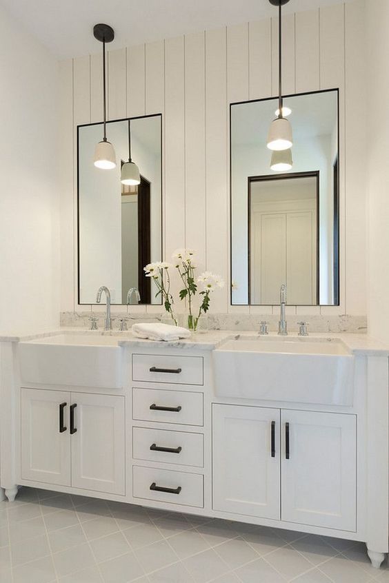 white bathroom with dual cast iron apron front sinks in vanity