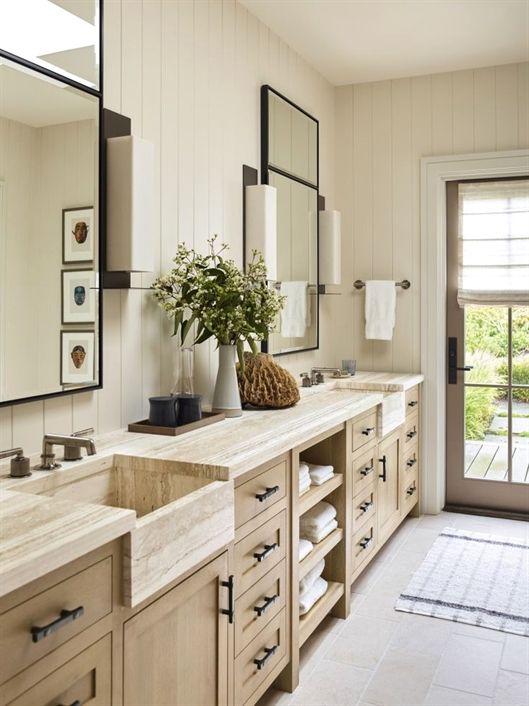 transitional bathroom with integrated apron front marble sinks in vanity