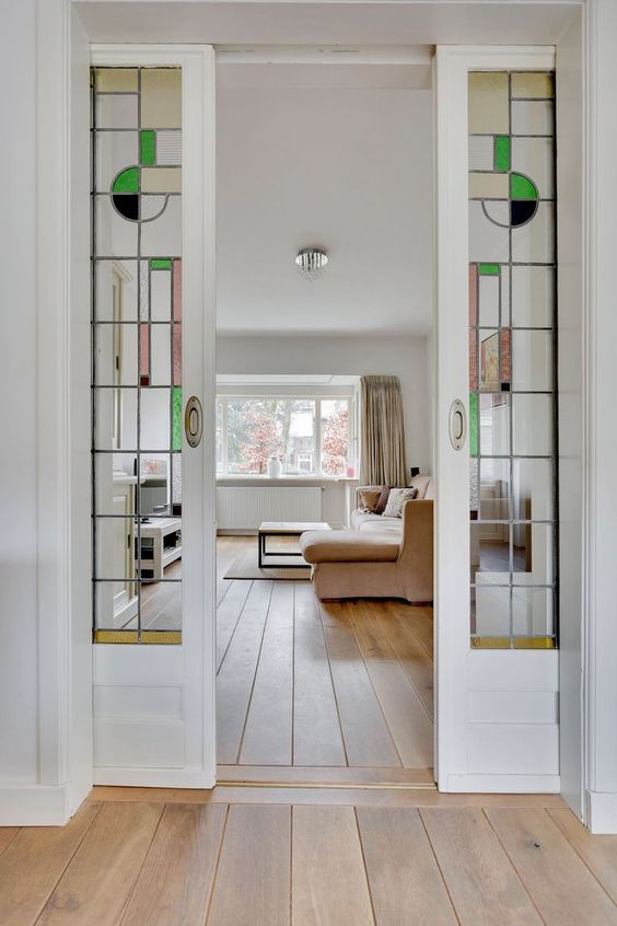 white french pocket doors with mid century stained glass leaded insert