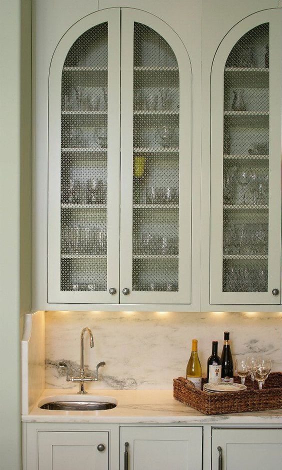 arched mint inset cabinet with wire mesh panel insert