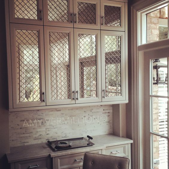 taupe overlap cabinet with antiqued mirror and wire mesh insert