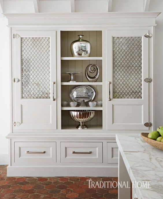 cream cabinets with wire mesh panel insert