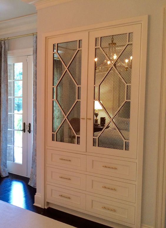 white cabinet with mirror and decorative mullion and wire mesh insert