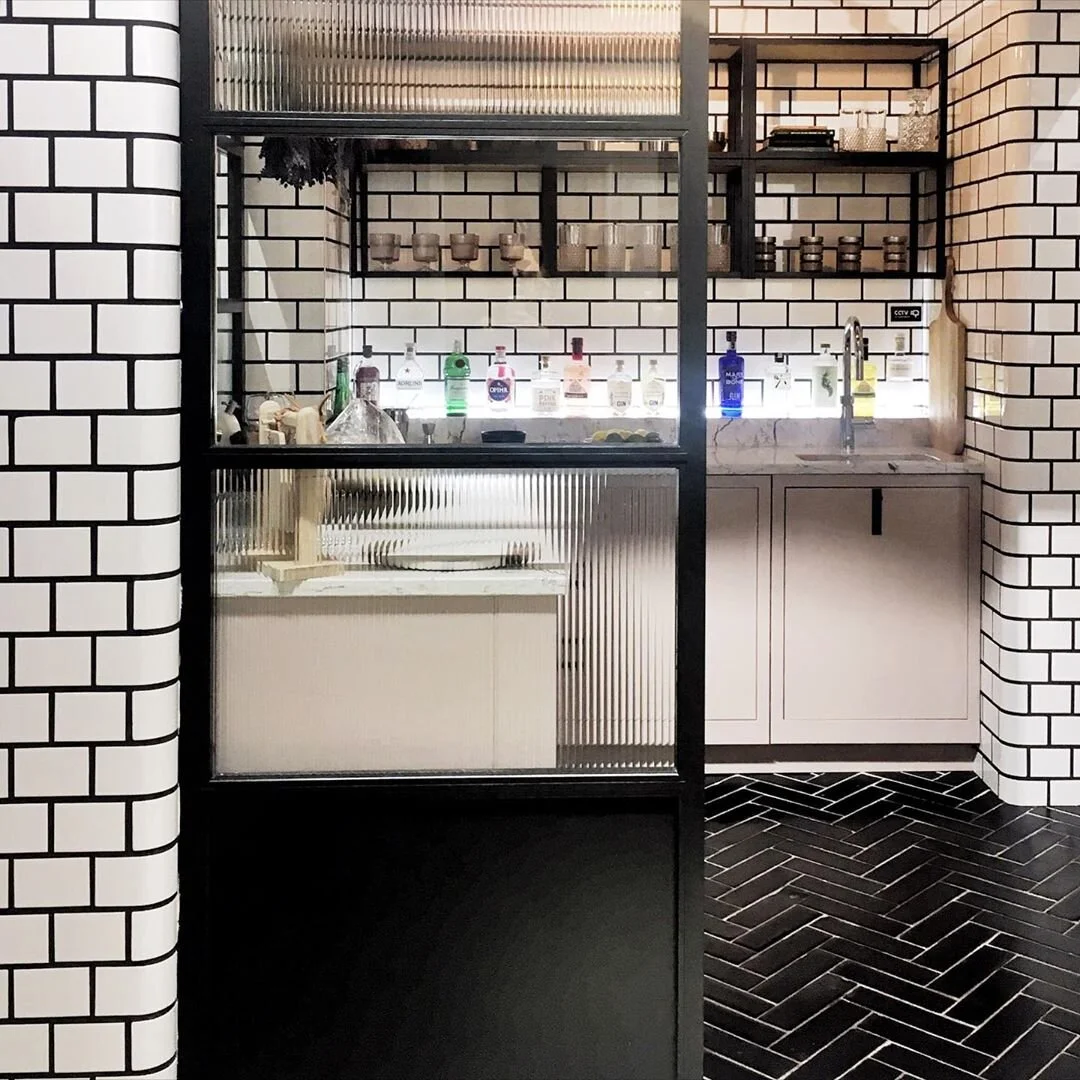 reeded glass kitchen partition black herringbone tile floor