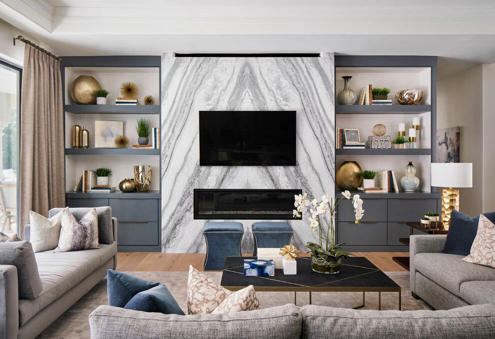 contemporary transitional family room bookmatched marble fireplace hearth grey taupe velvet curtains unlacquered brass lamp gold fixtures