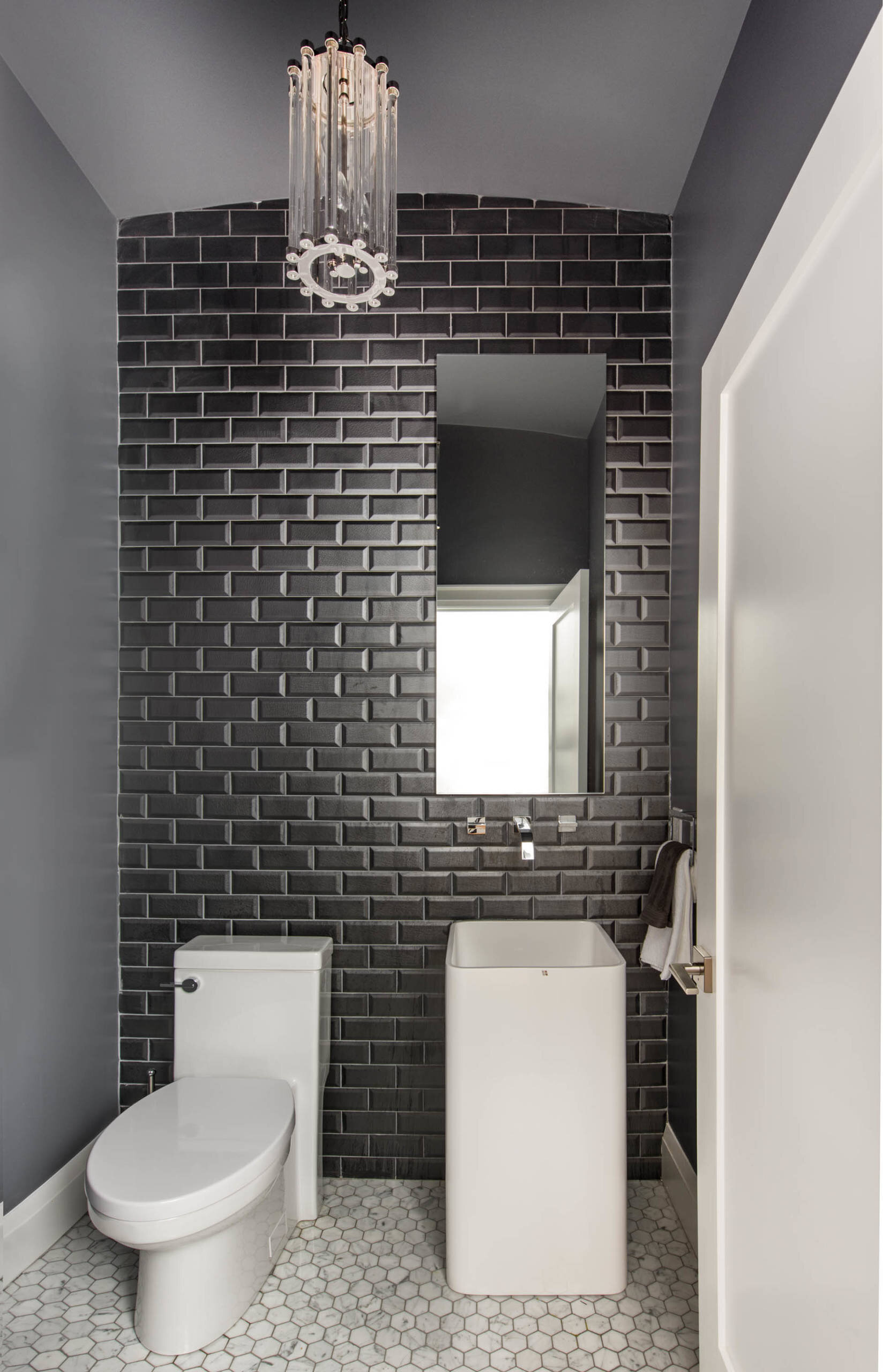 tiny powder room contemporary modern black subway tile wall mounted chrome faucet white pedestal carrara hex mosaic
