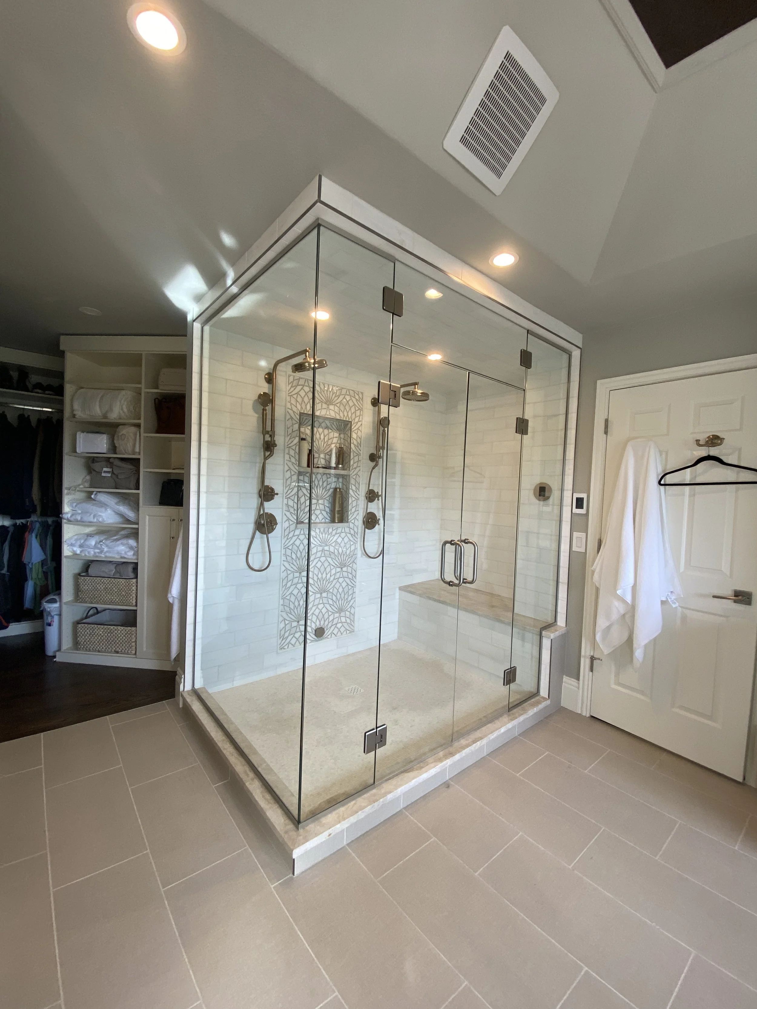 Beautiful custom Steam Shower installed in Lakewood, CO. This features heavy duty hinges, handles, and custom operating transom above these double doors.
