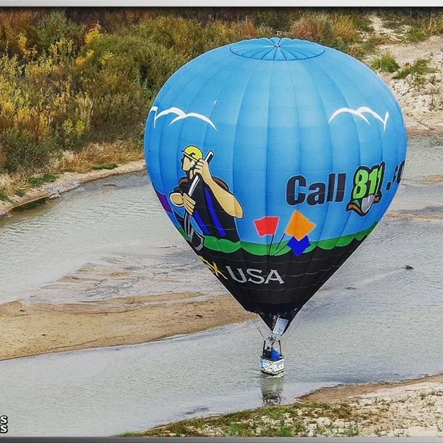 A splash and dash is a maneuver where the pilot sets the basket on top of a body of water. Too deep and your feet get wet, too high and your dry. Here the @coxutilityservices balloon performs a perfect splash and dash on the Rio Grande in Albuquerque