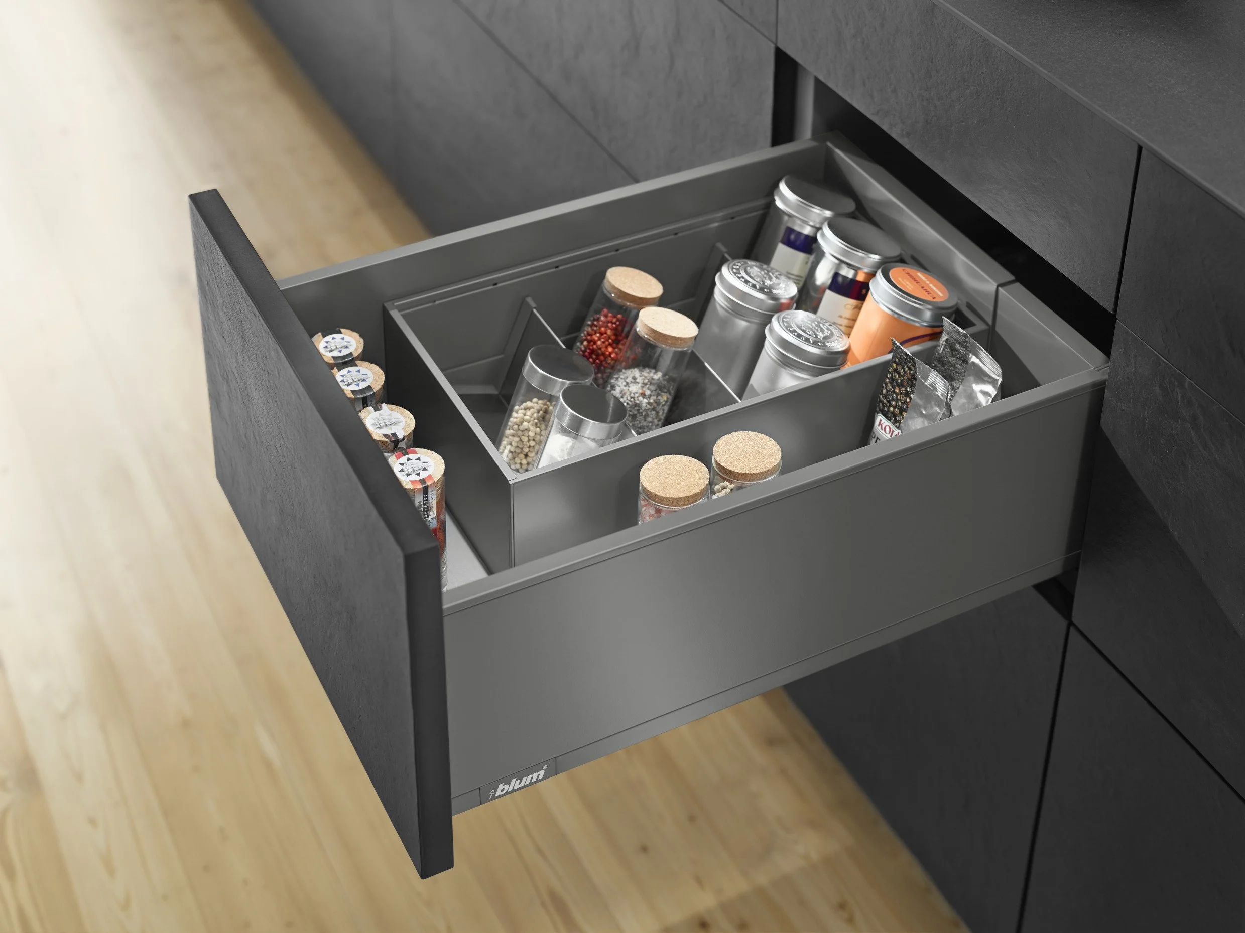 Blum Legrabox drawer system in Orion Grey with adjustable spice holders in an Atlantic kitchen cabinet