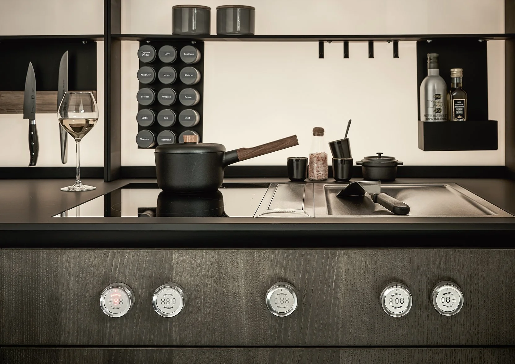 Dark oak next125 kitchen showing Bora professional 3.0 teppanyaki induction hob with front mounted control dials.