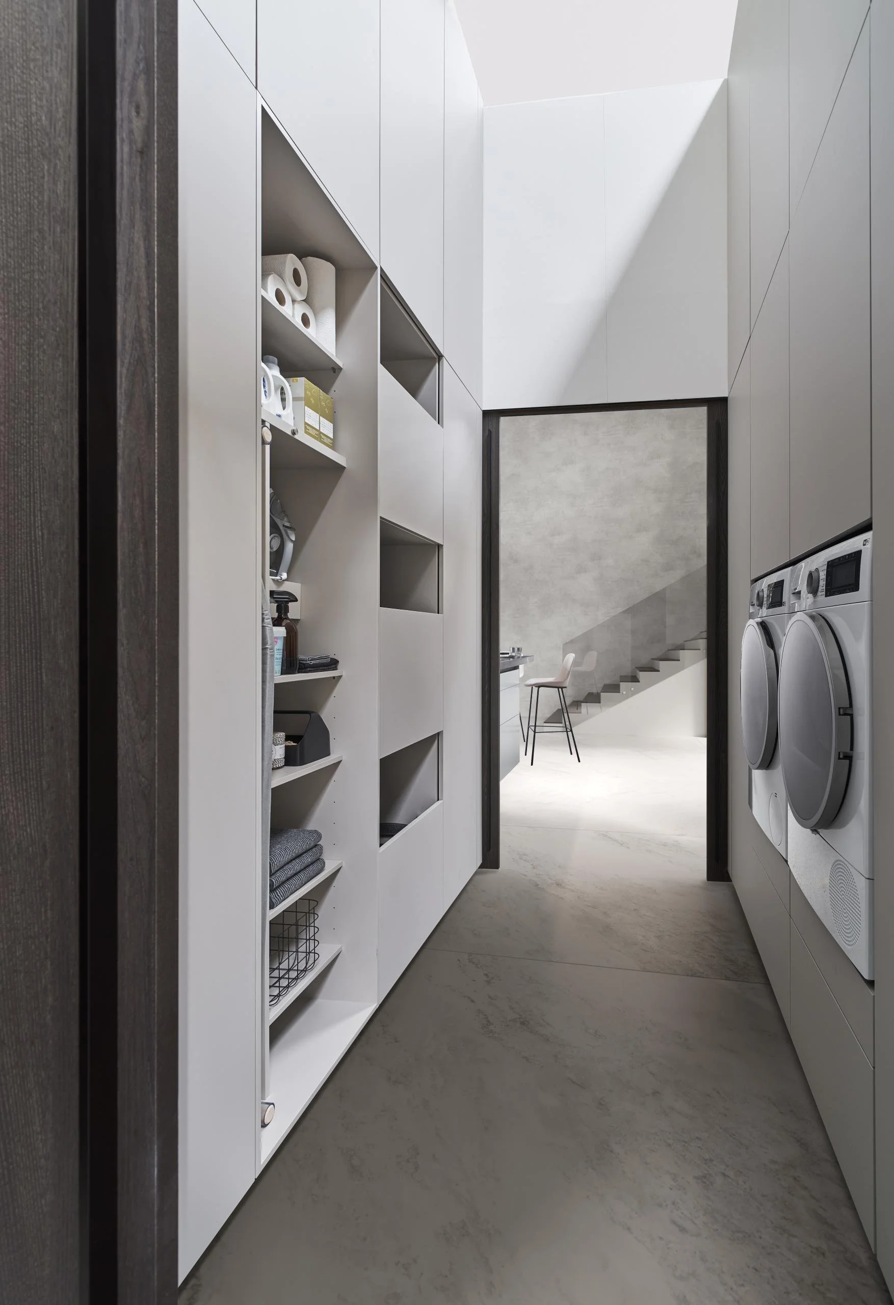 LEICHT utility room with stacked washing machine and tumble dryer housed within tall cabinetry