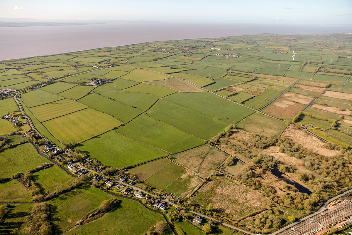 Looking south-west across Magor Marsh nature reserve towards Lower Grange Farm (top left) and Redwick (top centre).
